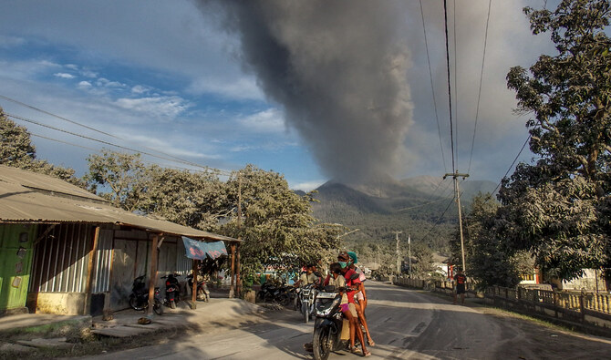 Indonesian rescuers dig through volcanic ash after eruption kills 9